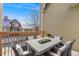 Exterior deck featuring a modern table and chairs set, and wood railings at 10329 W Fair Ave # C, Littleton, CO 80127