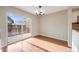 Bright dining area with hardwood floors, a modern light fixture, and a sliding door leading to a private outdoor deck at 10329 W Fair Ave # C, Littleton, CO 80127
