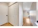 View of bedroom and closet in hallway, with wood floors and natural light coming in from window at 10329 W Fair Ave # C, Littleton, CO 80127