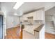 Updated kitchen with white cabinets, stainless steel appliances, and wood-look flooring at 10329 W Fair Ave # C, Littleton, CO 80127
