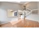 Bright open living room with high ceilings, hardwood floors, adjacent to the kitchen and a staircase to the upper level at 10329 W Fair Ave # C, Littleton, CO 80127