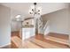 Open concept living room with wood floors, white staircase, and updated lighting at 10329 W Fair Ave # C, Littleton, CO 80127