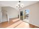 Living room with wood floors, staircase, high ceilings, and sliding glass door to deck at 10329 W Fair Ave # C, Littleton, CO 80127