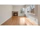 Living room featuring a fireplace, hardwood floors, and bright windows providing natural light at 10329 W Fair Ave # C, Littleton, CO 80127