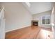 Bright living room featuring a fireplace and hardwood floors, with ample natural light from a large window at 10329 W Fair Ave # C, Littleton, CO 80127