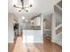 Open concept living room featuring wood floors, white staircase, and updated lighting fixtures at 10329 W Fair Ave # C, Littleton, CO 80127