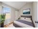 Comfortable bedroom features a modern design with a view of the neighborhood out the window at 10329 W Fair Ave # C, Littleton, CO 80127