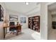 Bright home office with a dark wooden desk and large bookshelf at 10329 W Fair Ave # C, Littleton, CO 80127