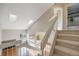 Bright entryway featuring vaulted ceilings, skylights, and an open staircase leading to the upper level at 10329 W Fair Ave # C, Littleton, CO 80127