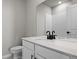 Modern bathroom features a white vanity, black faucet, and a large mirror reflecting the shower tiles at 27492 E 1St Ave, Aurora, CO 80018