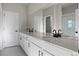 Bathroom featuring a double vanity, large mirror, white cabinetry, and tile flooring at 27492 E 1St Ave, Aurora, CO 80018
