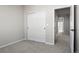 Neat bedroom features carpet flooring, a sliding door closet and a doorway to the rest of the house at 27492 E 1St Ave, Aurora, CO 80018