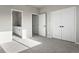 Bedroom featuring ensuite bathroom access, 2 closets and neutral carpeting at 27492 E 1St Ave, Aurora, CO 80018