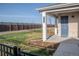 Inviting front porch with blue door, brick facade, and well-manicured lawn and garden area at 27492 E 1St Ave, Aurora, CO 80018