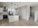 Open concept kitchen with island, stainless steel appliances, and modern pendant lighting at 27492 E 1St Ave, Aurora, CO 80018