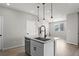 Kitchen island with stainless steel dishwasher, granite countertop, and pendant lighting at 27492 E 1St Ave, Aurora, CO 80018