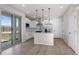 Open kitchen with stainless appliances, kitchen island, and sliding doors leading to backyard at 27492 E 1St Ave, Aurora, CO 80018