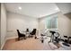 Finished basement featuring workout area with weight bench and table for recreation and fitness at 15569 W La Salle Ave, Lakewood, CO 80228