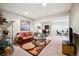 Finished basement featuring a leather couch, glass coffee table, and adjacent office space at 15569 W La Salle Ave, Lakewood, CO 80228