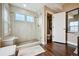 Modern bathroom with frameless glass shower, built-in seat, and view of water closet at 15569 W La Salle Ave, Lakewood, CO 80228