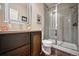 Modern bathroom featuring a sleek vanity, framed mirror, and a glass-enclosed walk-in shower at 15569 W La Salle Ave, Lakewood, CO 80228