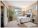Cozy bedroom with natural light, neutral walls, and decorative plants provides a relaxing atmosphere at 15569 W La Salle Ave, Lakewood, CO 80228