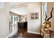 Elegant entryway with hardwood floors, stylish decor, and views of the kitchen and outdoor patio at 15569 W La Salle Ave, Lakewood, CO 80228