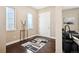 Open entryway featuring hardwood floors, neutral paint, and easy access to the living area at 15569 W La Salle Ave, Lakewood, CO 80228