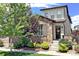 Charming two-story home featuring stone accents, a welcoming front porch, and beautiful landscaping at 15569 W La Salle Ave, Lakewood, CO 80228