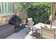 Cozy patio space with outdoor table, seating, grill, and privacy landscaping at 15569 W La Salle Ave, Lakewood, CO 80228
