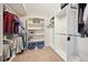 Walk-in closet with built in shelving, clothes racks, and carpeted floor at 15569 W La Salle Ave, Lakewood, CO 80228
