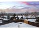 Snowy backyard with mountain views and wood fence at 10350 W Burgundy Ave, Littleton, CO 80127