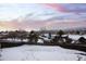 View of backyard shows snow covered yard and distant mountains at 10350 W Burgundy Ave, Littleton, CO 80127