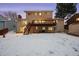 Two story home with deck and snowy backyard at 10350 W Burgundy Ave, Littleton, CO 80127