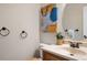 Clean bathroom with vanity, toilet, and oval mirror at 10350 W Burgundy Ave, Littleton, CO 80127