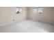 Spacious carpeted bedroom with large windows offering natural light at 10350 W Burgundy Ave, Littleton, CO 80127