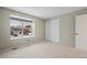 Carpeted bedroom with window seat and sliding closet doors at 10350 W Burgundy Ave, Littleton, CO 80127