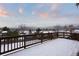 View from deck features snowy backyard and mountain views at 10350 W Burgundy Ave, Littleton, CO 80127