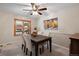 Dining room with dark wood table and chairs, ceiling fan, and window at 10350 W Burgundy Ave, Littleton, CO 80127