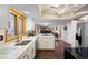 Bright kitchen with white cabinets, stainless steel appliances, and a large island at 10350 W Burgundy Ave, Littleton, CO 80127