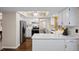 Modern kitchen with white cabinets and stainless steel appliances at 10350 W Burgundy Ave, Littleton, CO 80127