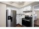 Stainless steel appliances and white cabinets in kitchen at 10350 W Burgundy Ave, Littleton, CO 80127