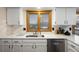 Kitchen with white cabinets, double sink, and a view at 10350 W Burgundy Ave, Littleton, CO 80127