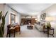 Living room with brick fireplace, comfy seating, and large window at 10350 W Burgundy Ave, Littleton, CO 80127