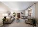 Living room with a sofa, armchairs, coffee table, and large window at 10350 W Burgundy Ave, Littleton, CO 80127