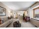 Living room with open floor plan, view into kitchen and window view at 10350 W Burgundy Ave, Littleton, CO 80127