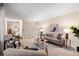 Living room with sofa, chairs, coffee table, and view into kitchen at 10350 W Burgundy Ave, Littleton, CO 80127