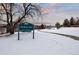 Snowy path leads to Westbury Park playground, pavilion, and address sign at 10350 W Burgundy Ave, Littleton, CO 80127