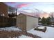 Tan colored storage shed in snowy backyard at 10350 W Burgundy Ave, Littleton, CO 80127