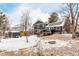 The spacious backyard features a deck, fire pit, storage shed, and snow-covered ground at 2014 S Pagosa St, Aurora, CO 80013